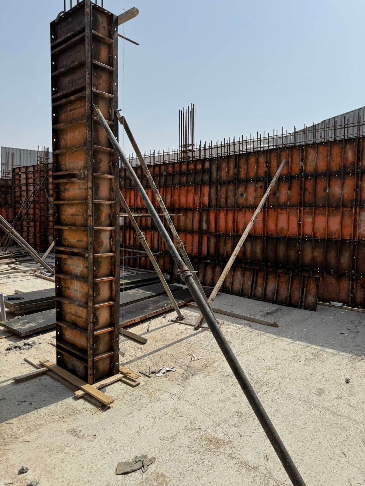 Steel column formwork panels with props on active construction site